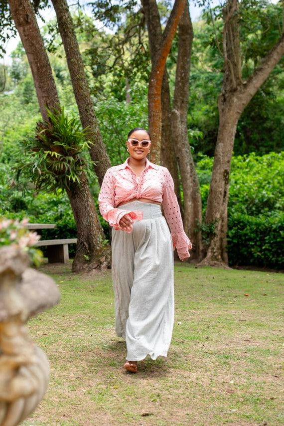 Person walking in a garden with trees and plants around